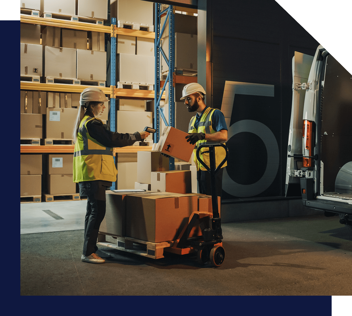 Warehouse workers loading boxes into van.